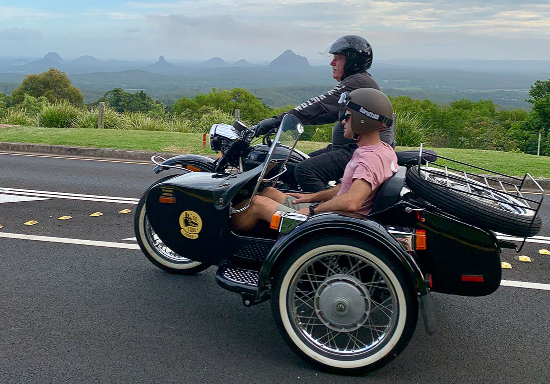 Man riding motorbike with man in sidecar around the Sunshine Coast Hinterland